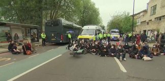 UK protesters block bus in attempt to stop asylum seekers from being moved to a barge